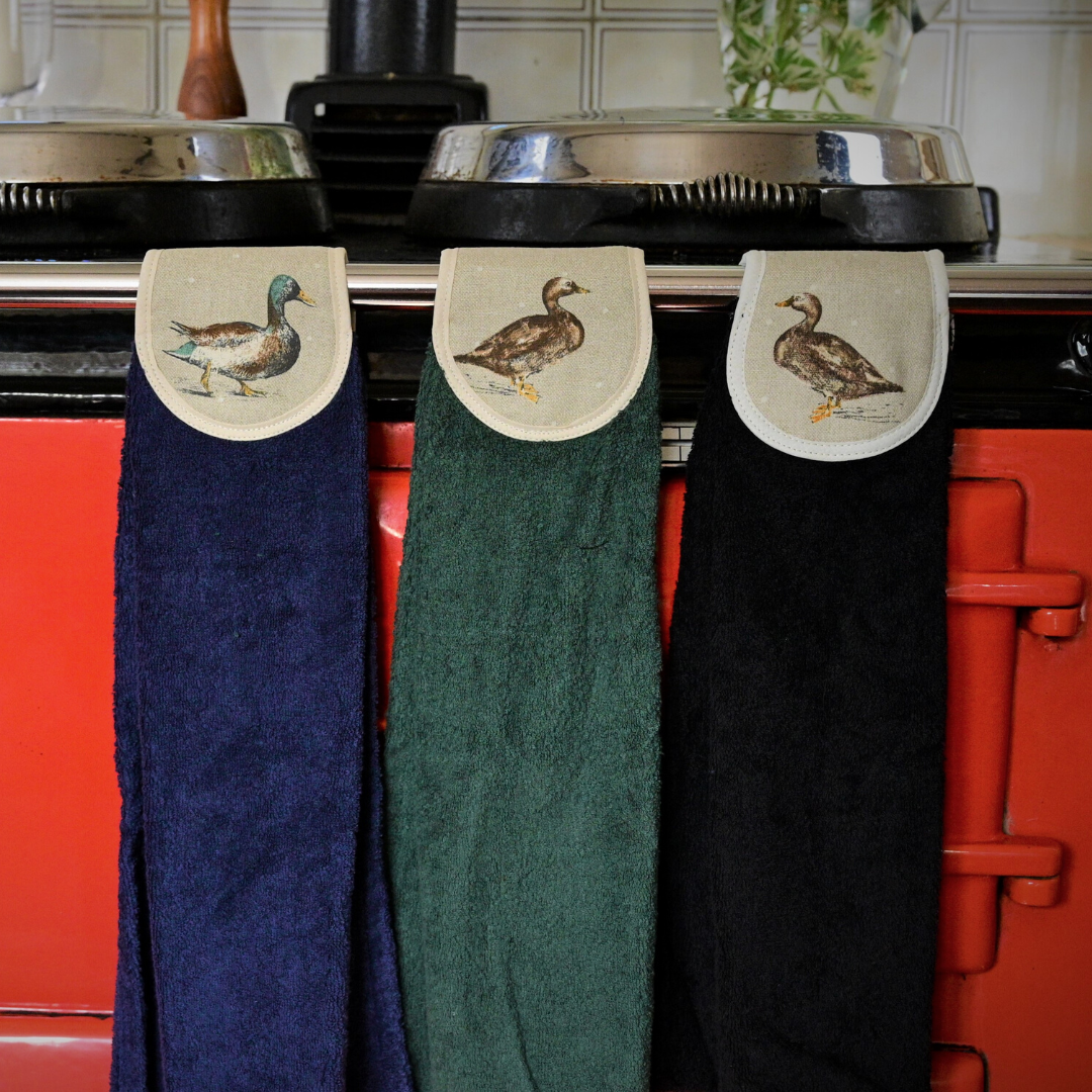 navy, green and black hang ups in mallard ducks on red aga rail