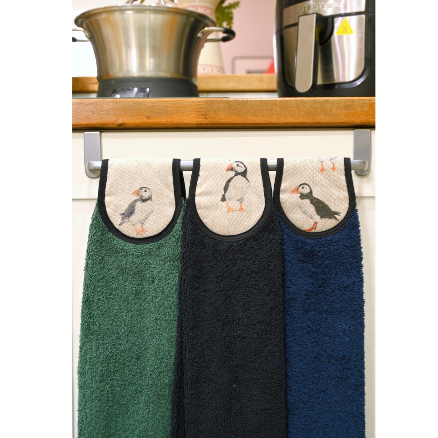 another of three colours of puffins hang ups towels on cooker rail