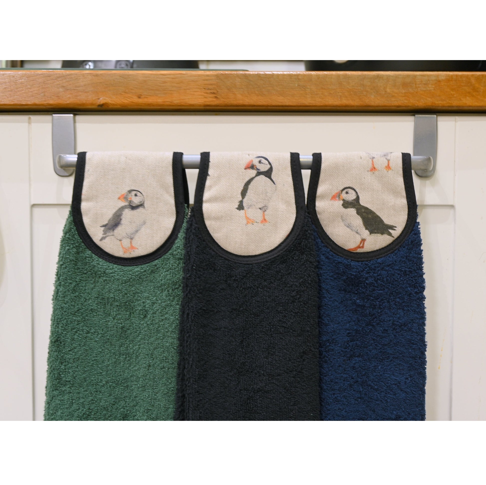 3 colours of puffins hang ups towels on cooker rail