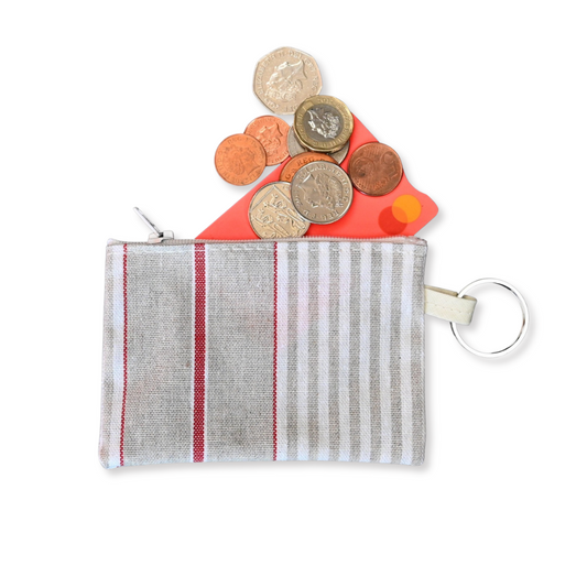 red stripe purse with coins spilling out