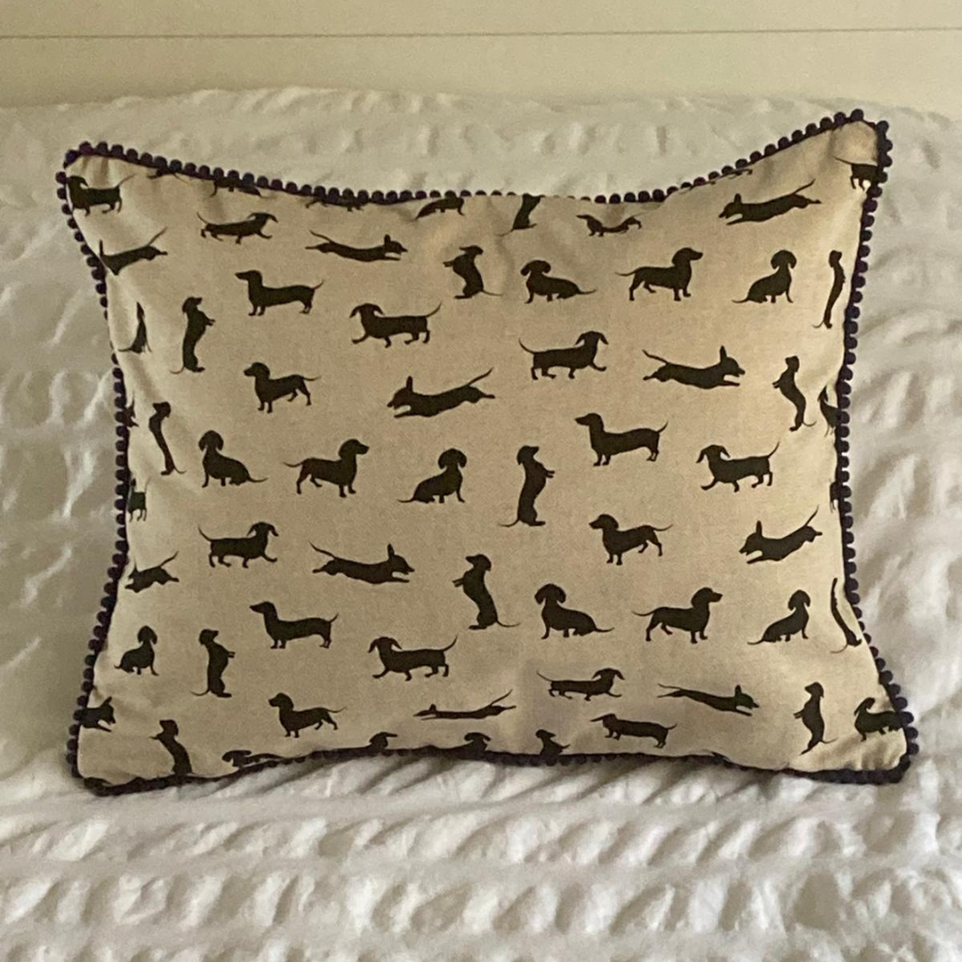 navy trim black dachshund cushion on bed
