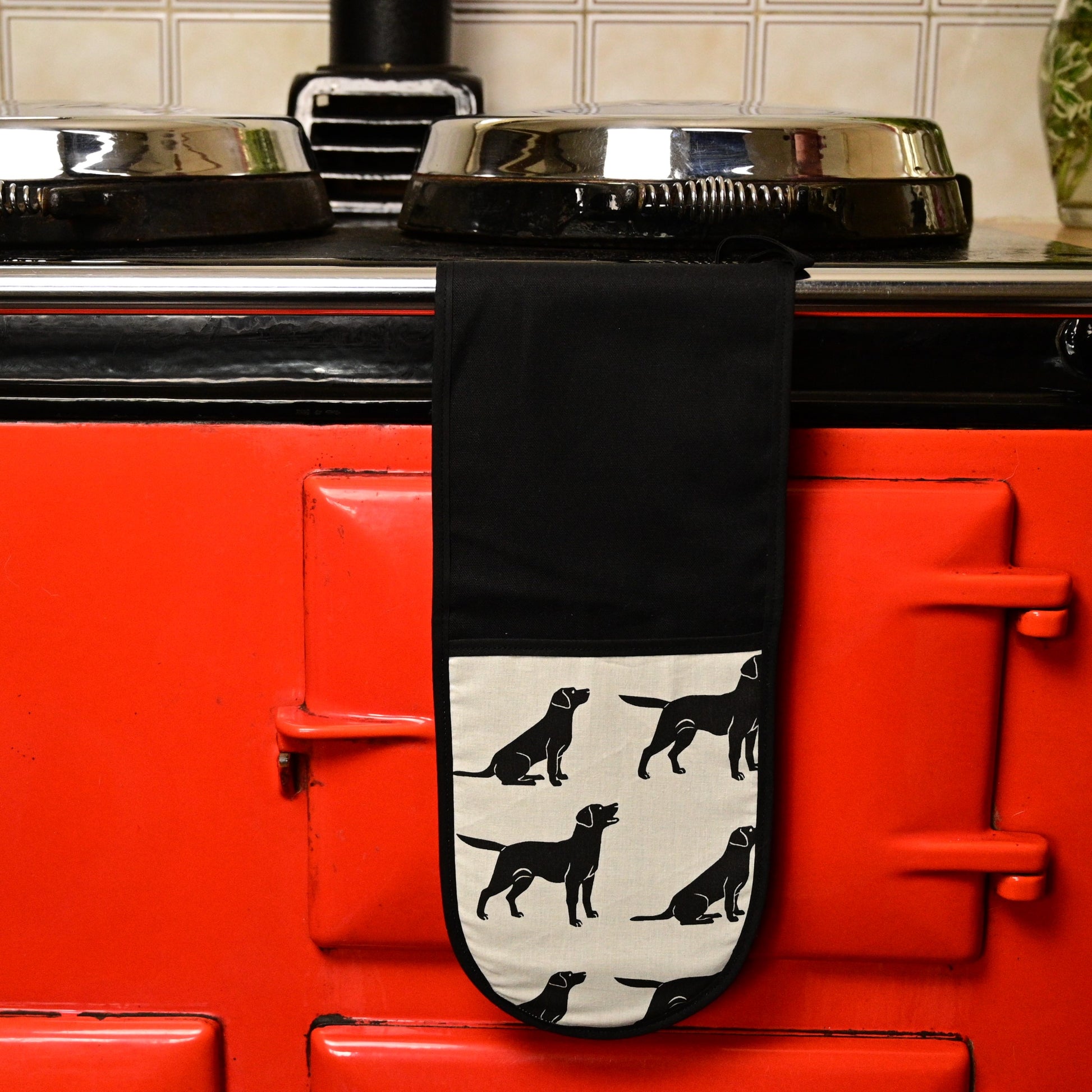 black labrador oven gloves hung up on aga
