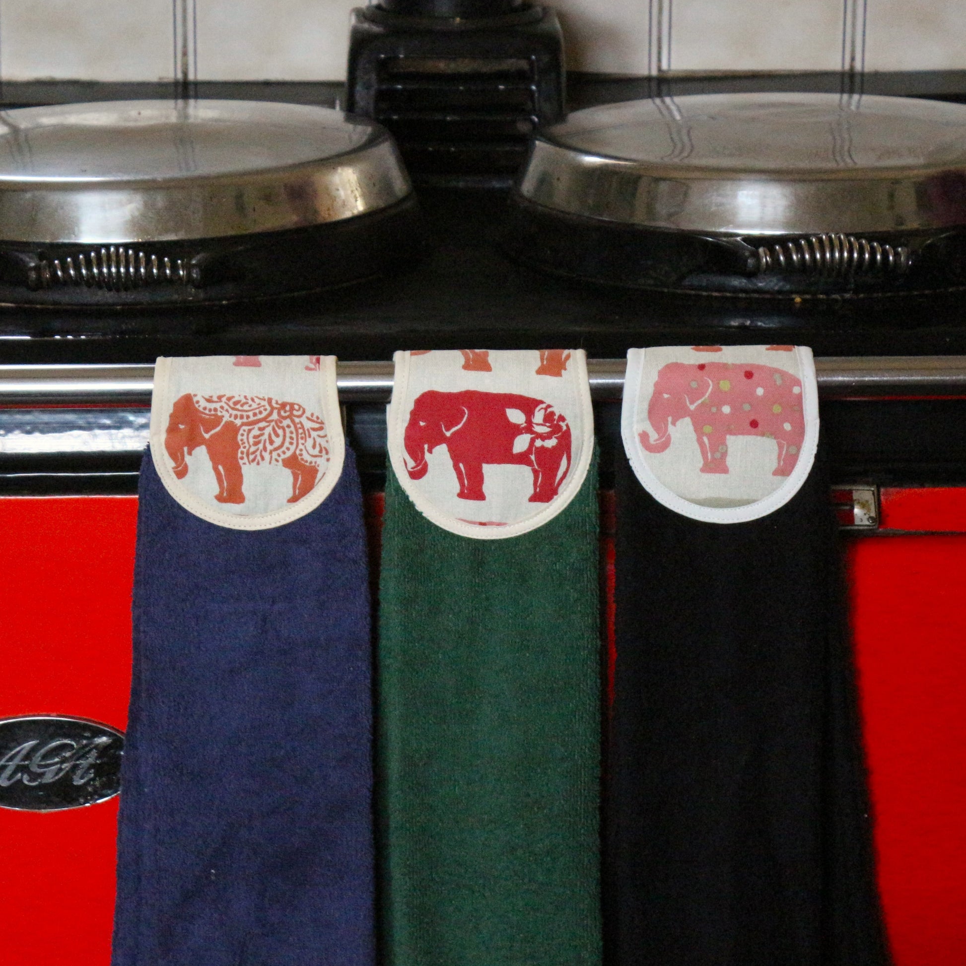 blue, green and black hang ups in spice elephant design on red aga