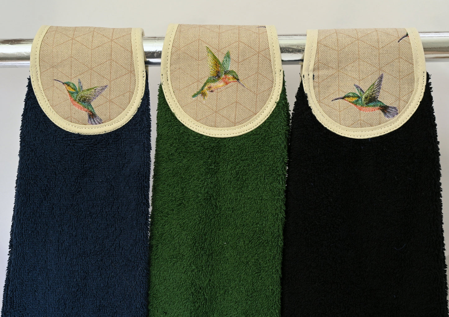 humming birds hang ups in navy, green and black on rail