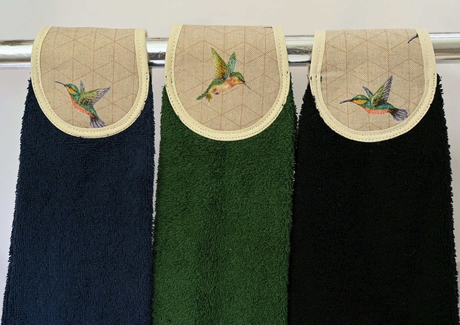 humming birds hang ups in navy, green and black on rail
