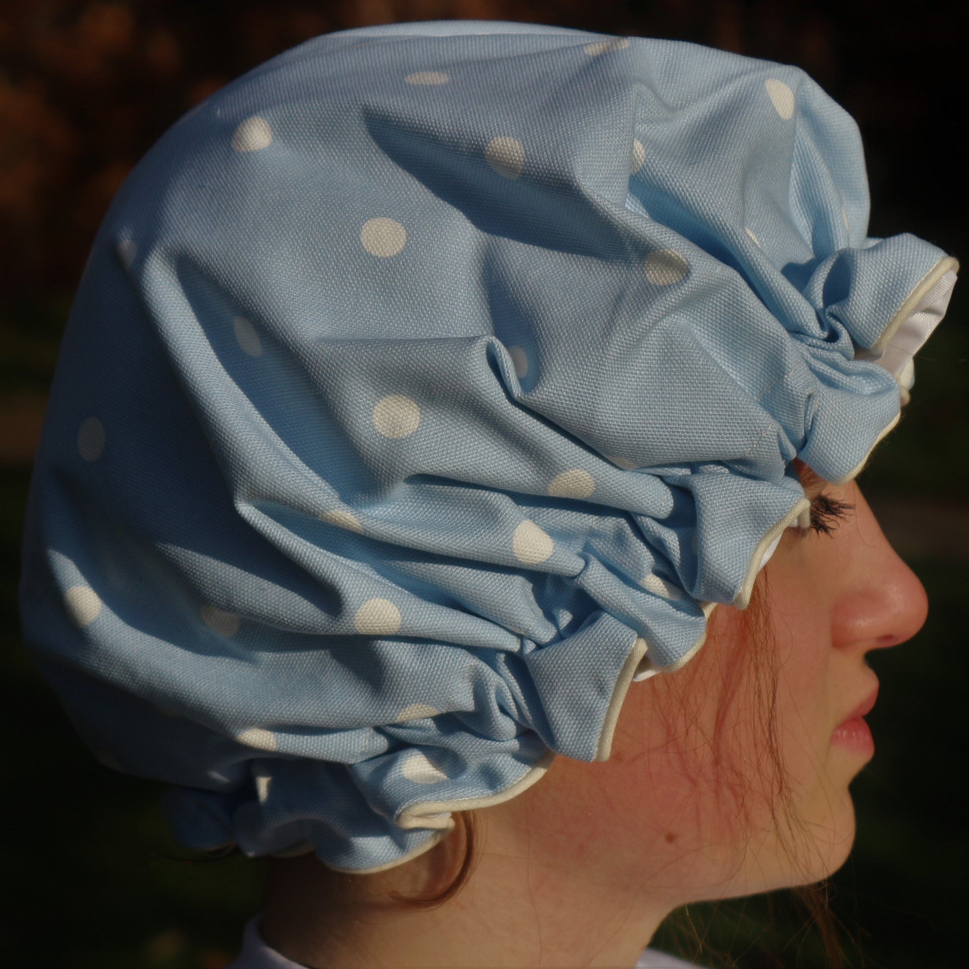 Shower Hat blue spots pictured outside on head