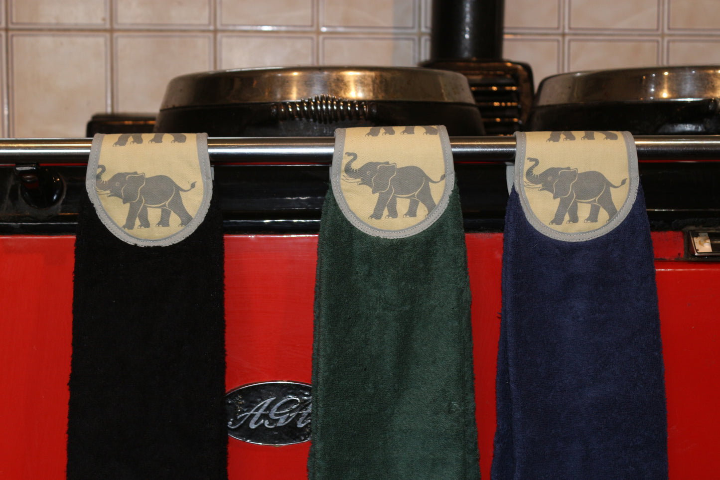 navy, green and black yellow elephants hang ups on rail of red aga