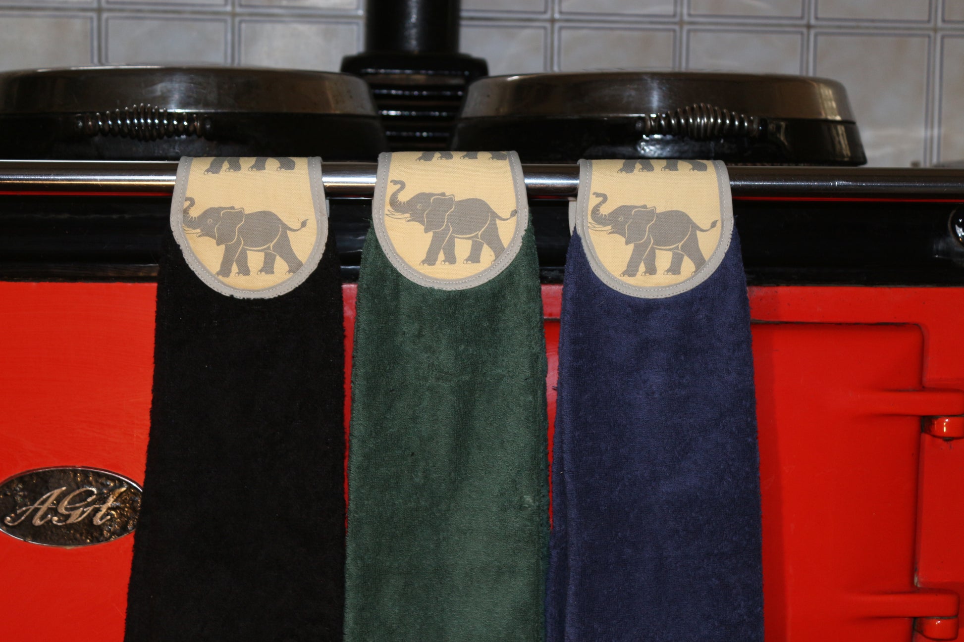 navy, green and black yellow elephants hang ups on rail of red aga