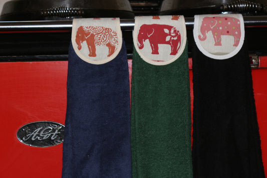 blue, green and black hang ups in spice elephant design on red aga