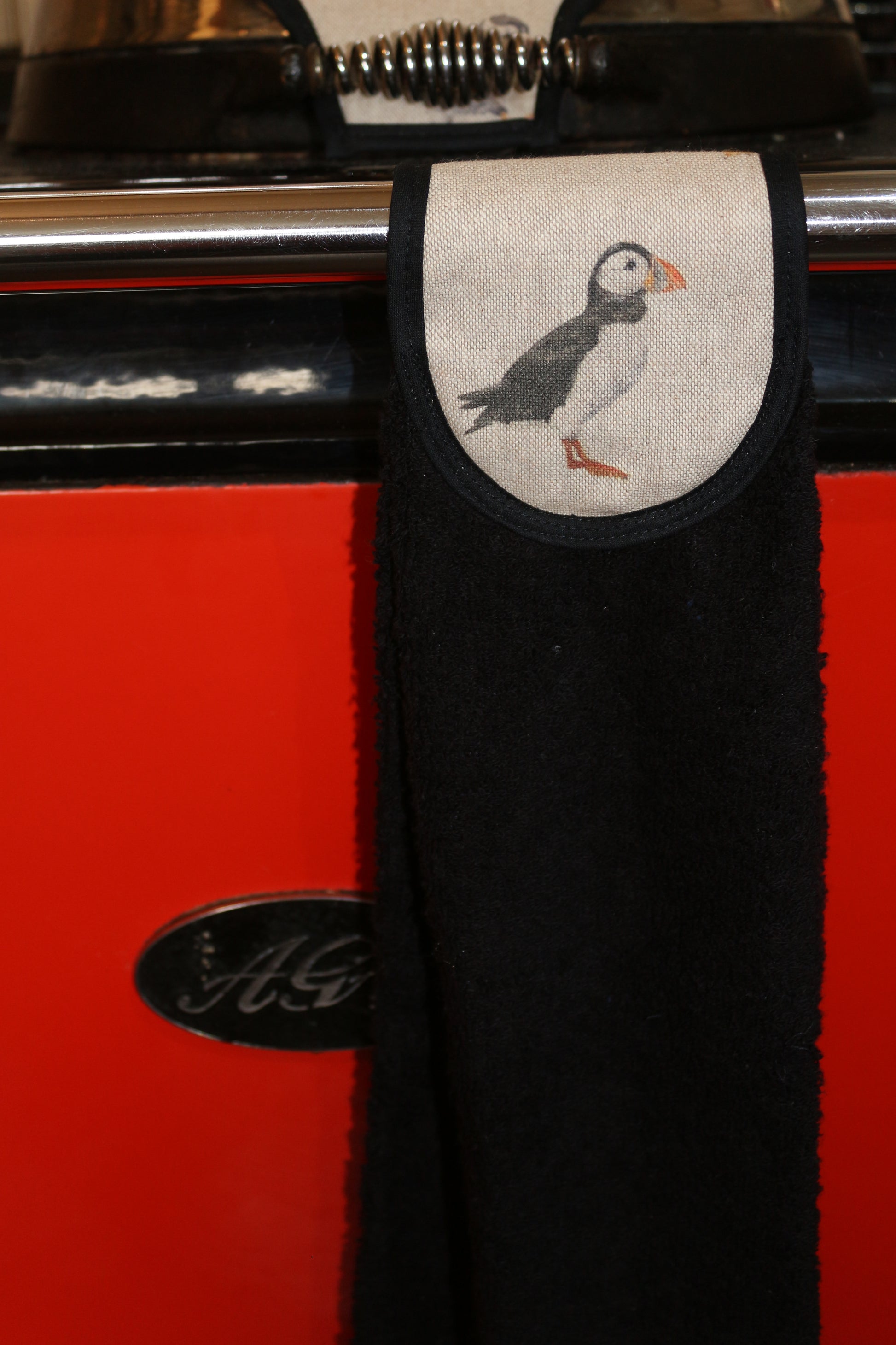 puffins hang up towel on red aga