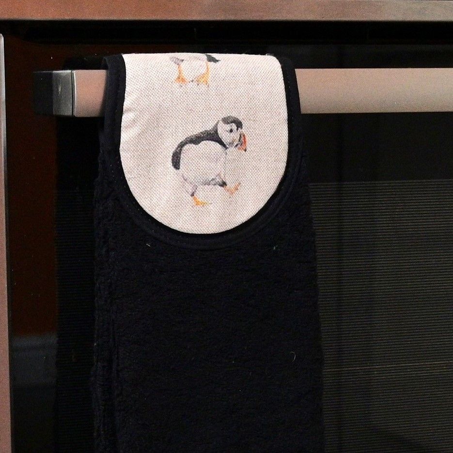 puffins hang up towel on cooker rail