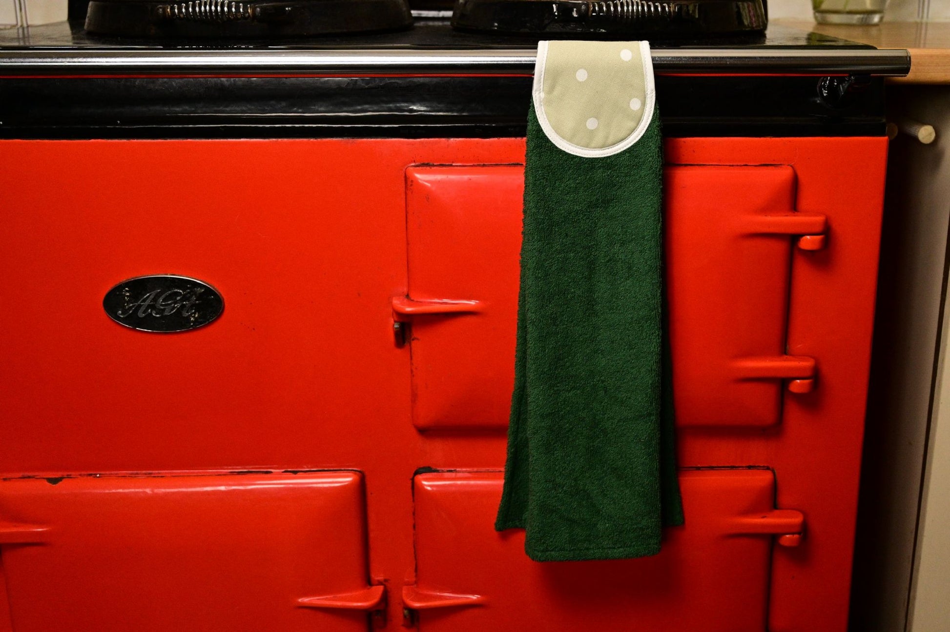 green spots hang up towel on red aga rail
