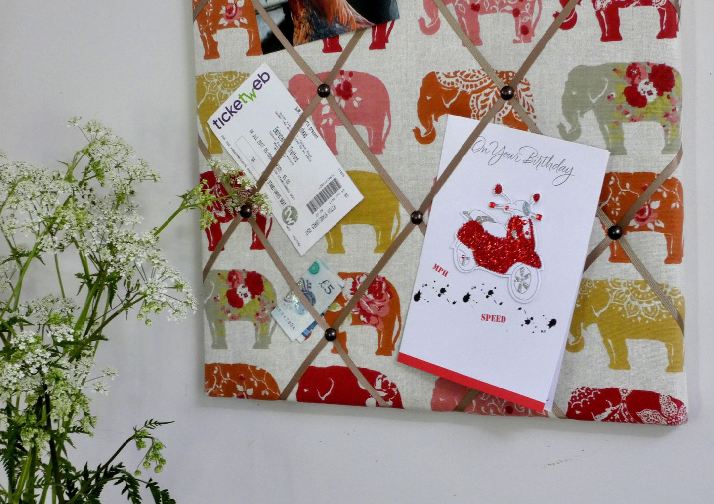spice elephant notice board lifestyle on wall with cards and tickets on