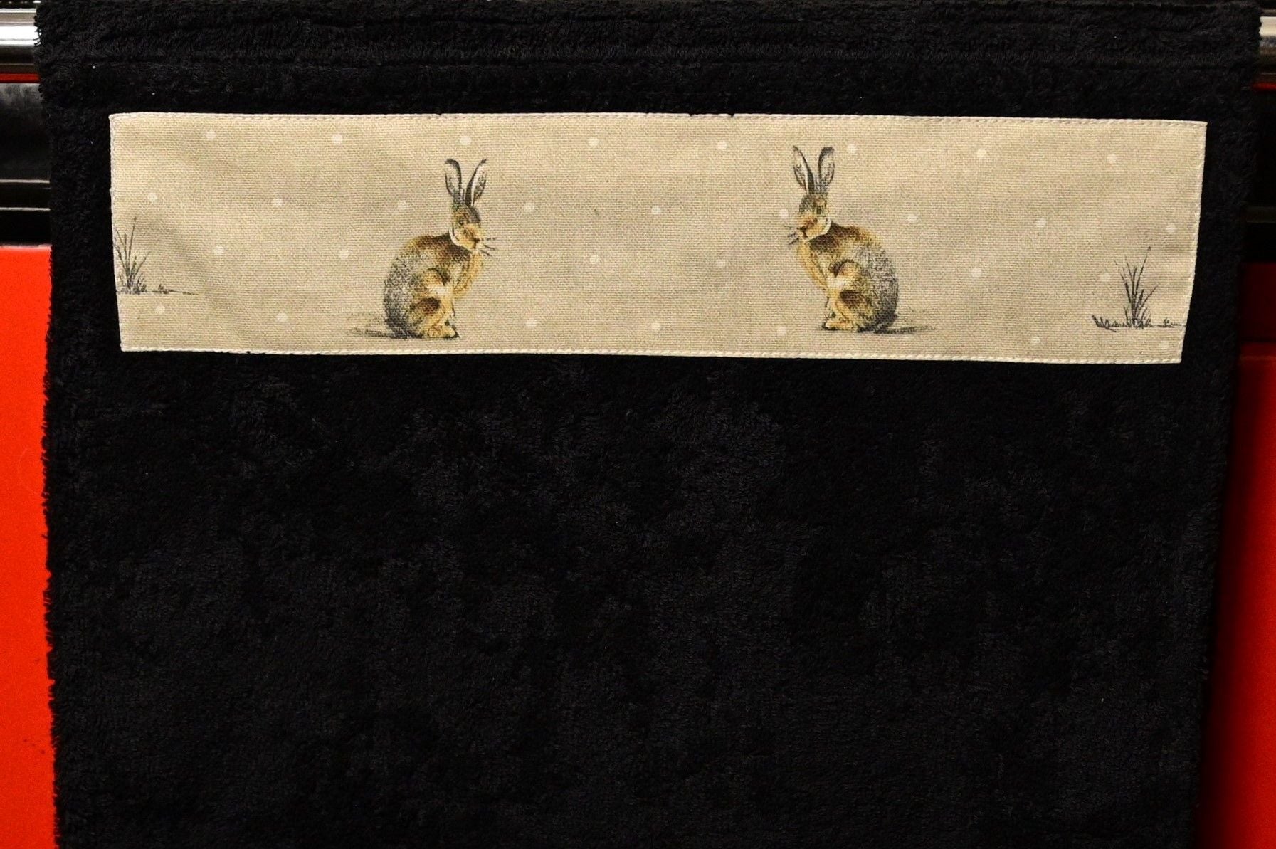 black kitchen towel on rail close up of hares design